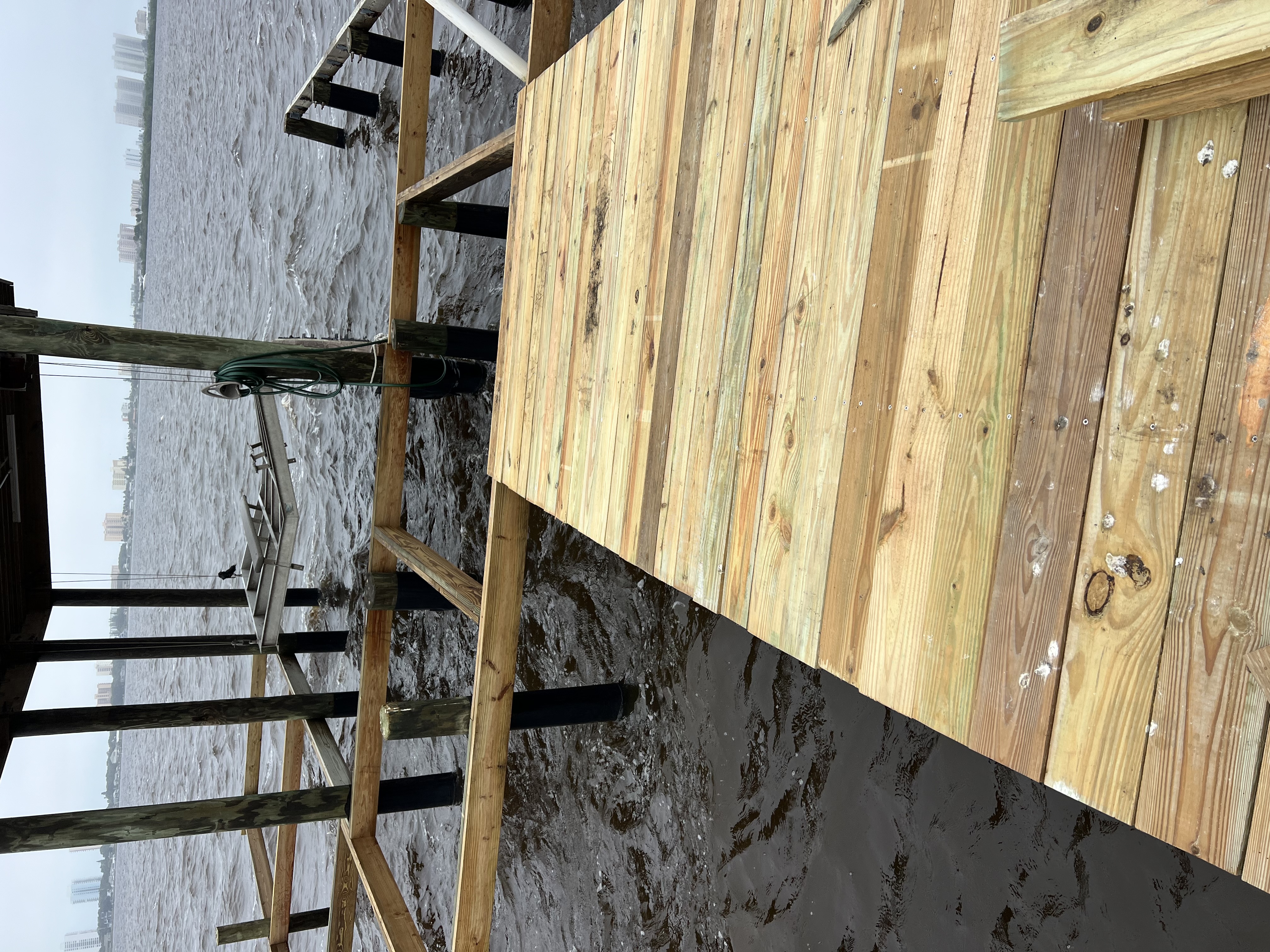 Boat lift cradle and boathouse framing over the water